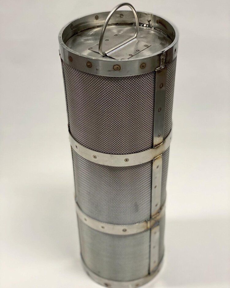 Cylindrical metal mesh filter with a handle and metal bands.