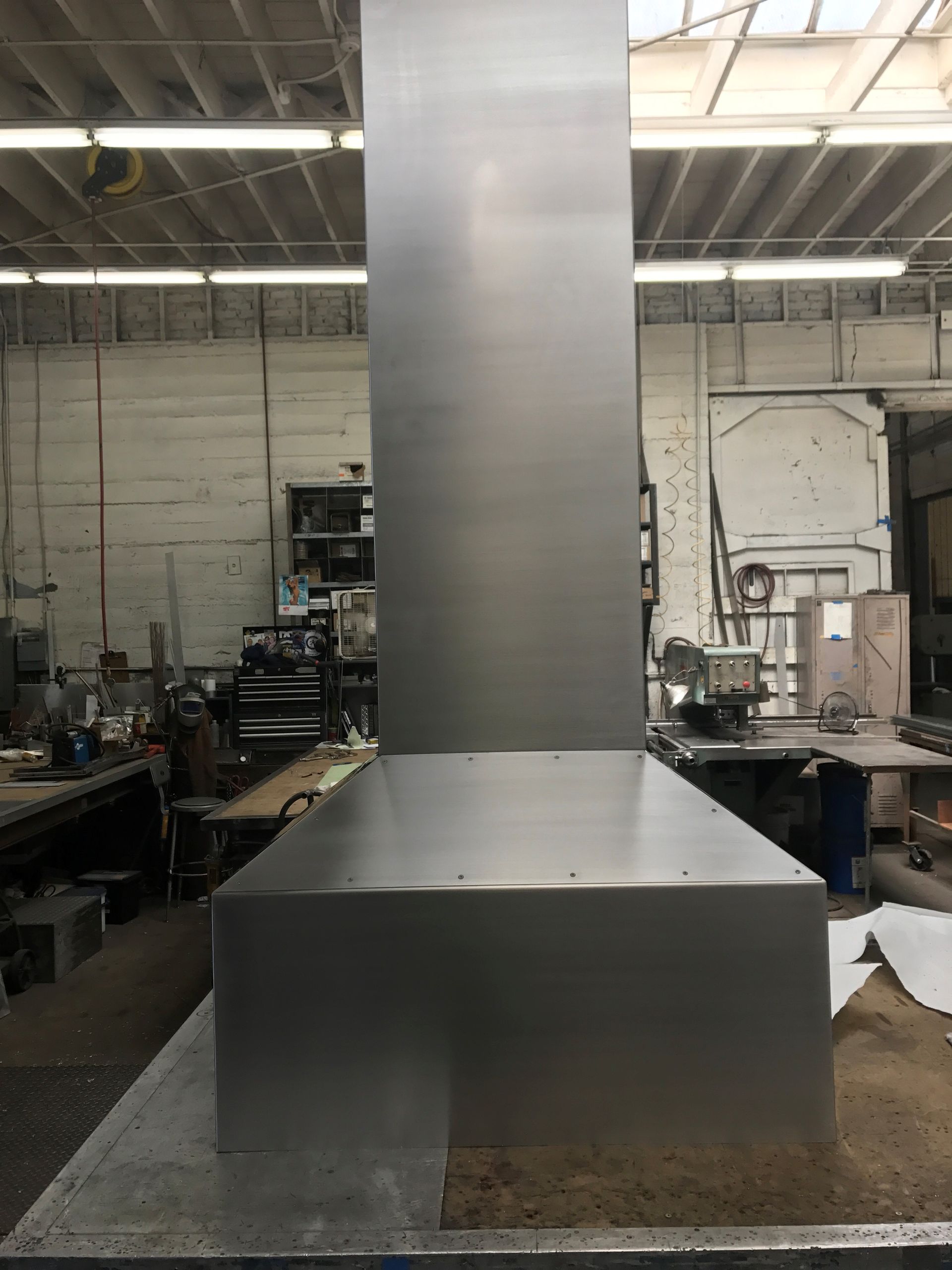 Stainless steel commercial kitchen exhaust hood, ready for installation.