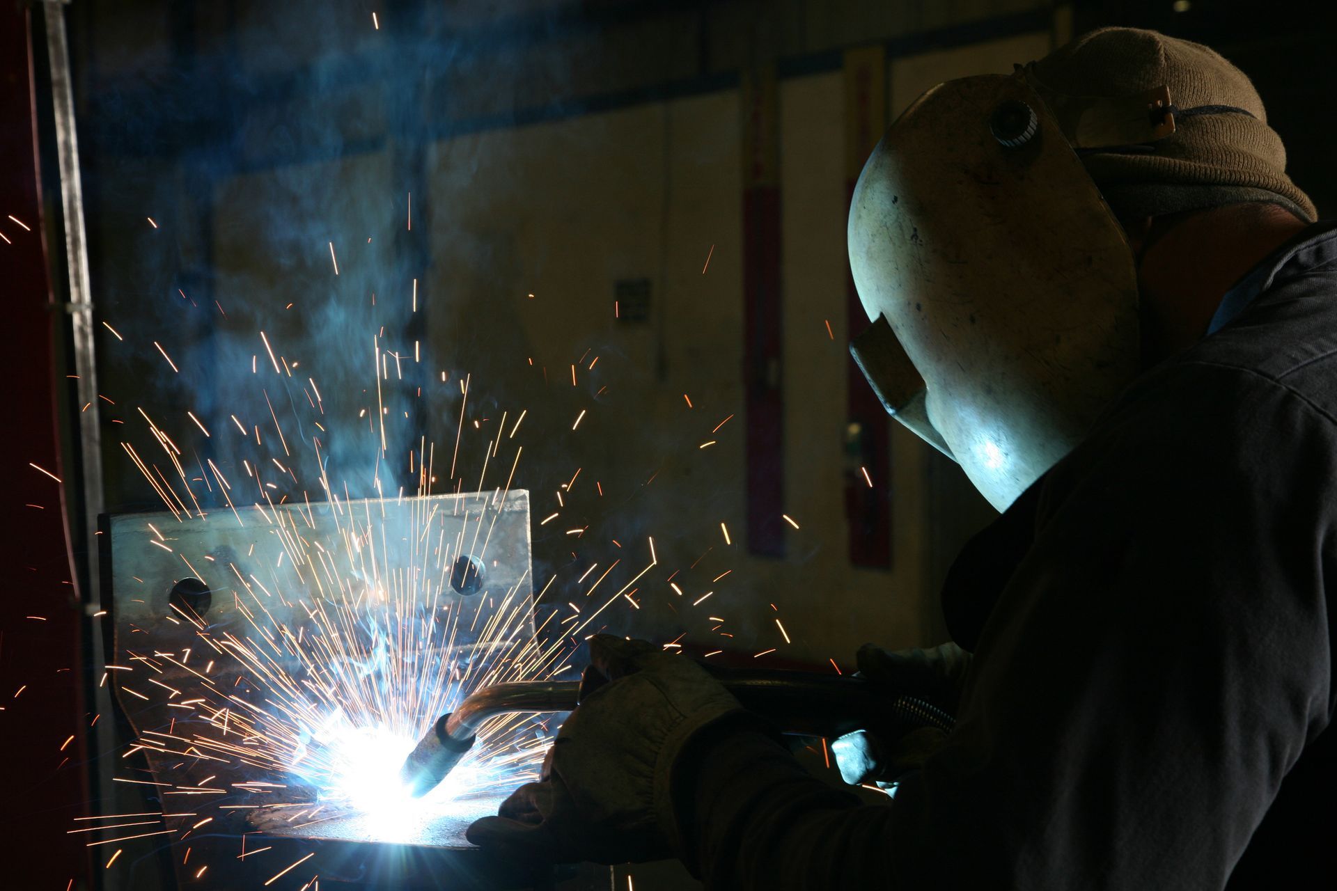 Man welding at Ballard Sheet Metal Works, expertly handling custom metal fabrication.