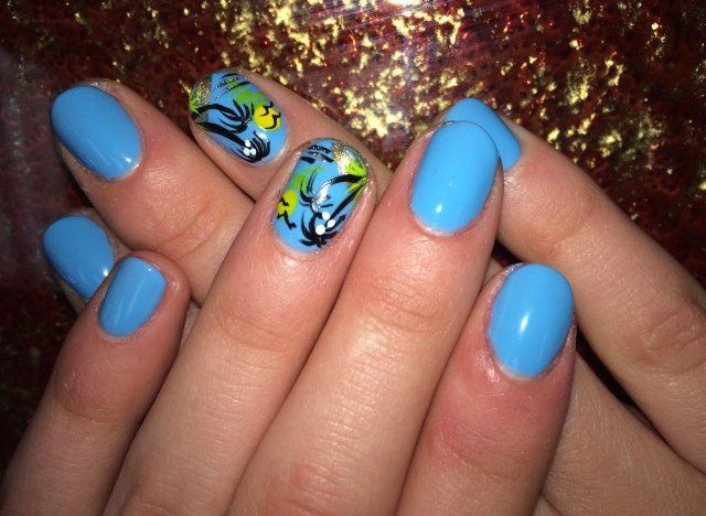 Light blue nails with floral designs on two fingers.