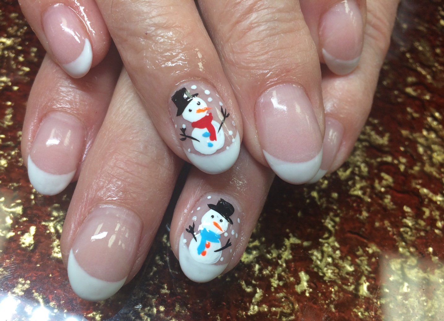 French manicure with snowman nail art; a holiday design.