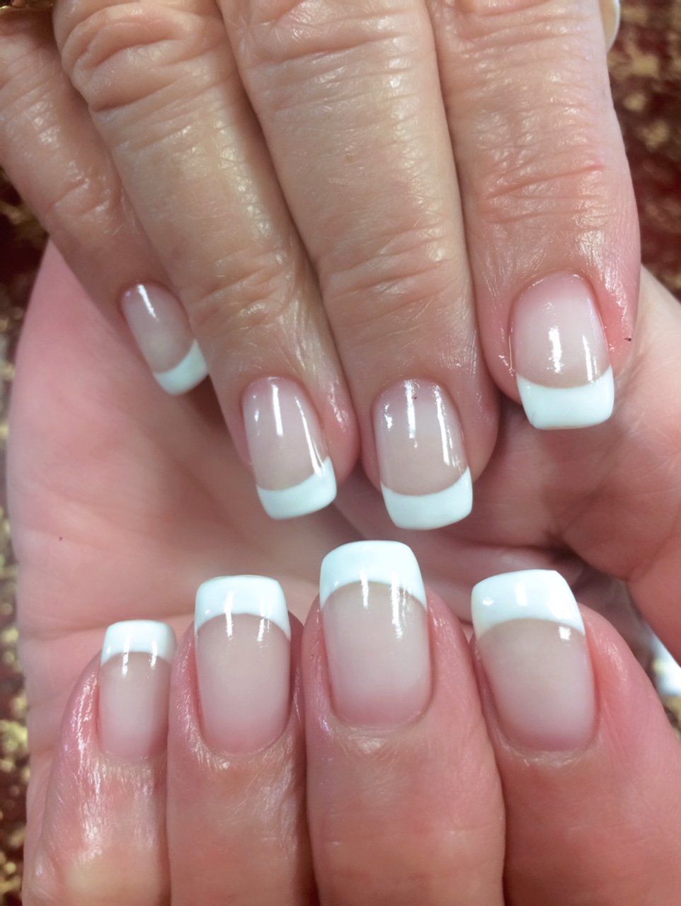 French manicure with white tips on square-shaped nails.