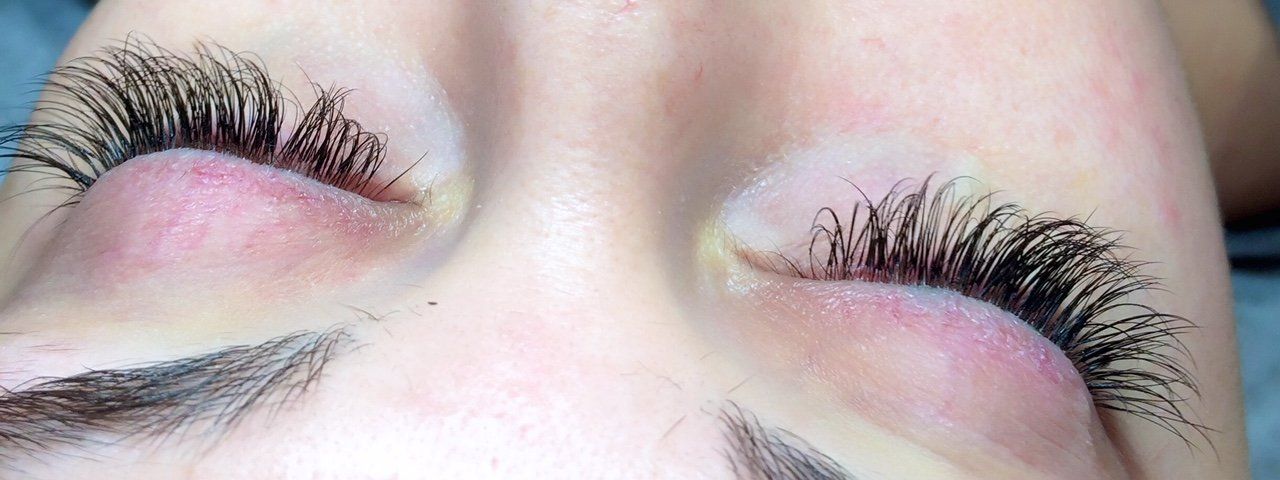 Close-up of eyes with long, thick, dark eyelashes and closed lids.