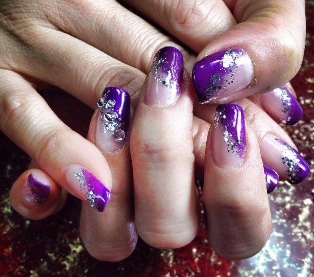 Purple ombre nails with silver glitter and rhinestones.