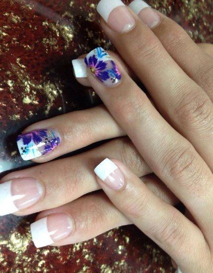 Hands with French tip nails and floral accent nails.