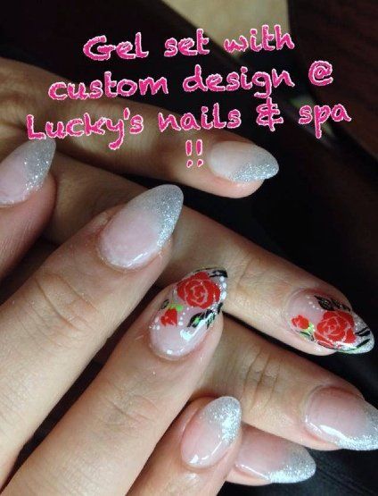 Gel nail set with custom rose design at Lucky's Nails & Spa. Glitter tips, pink and red roses.