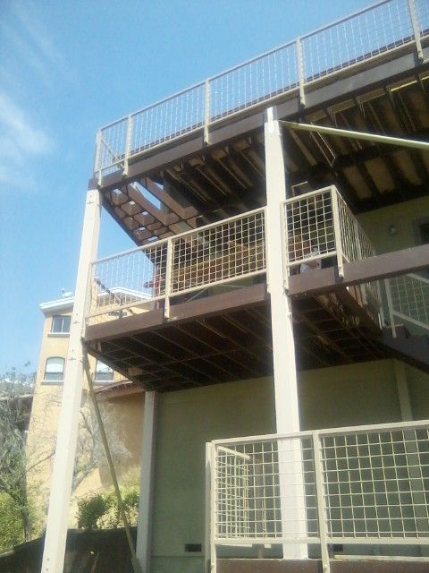 A Building With A Balcony And Stairs On The Second Floor -  Los Angeles, CA - New Castle Remodeling