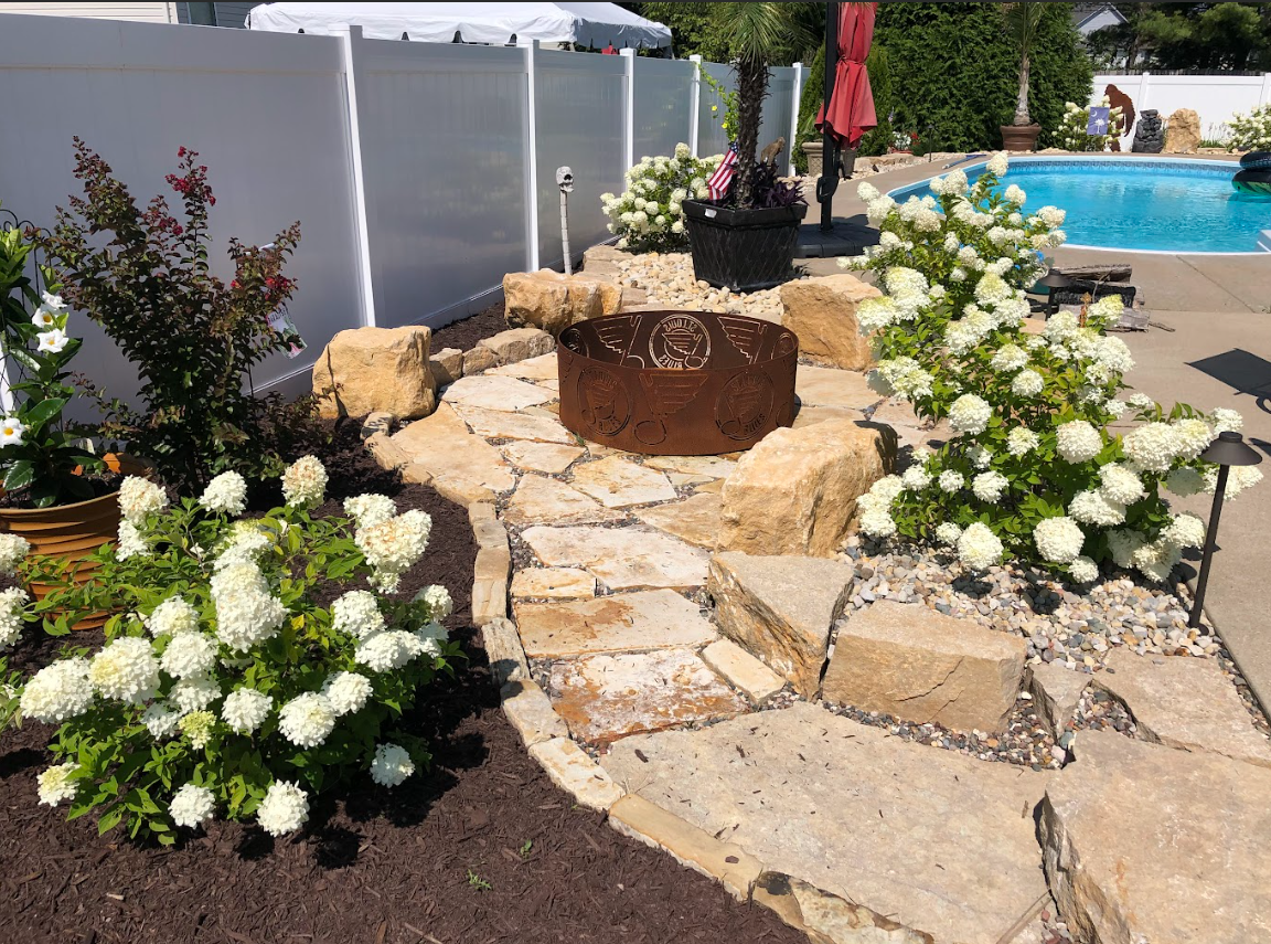 Beautiful flowers around hardscape| Hackmann Lawn STL