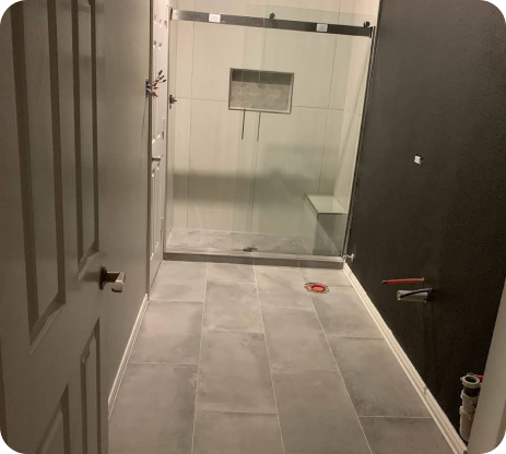 A bathroom with a sliding glass shower door