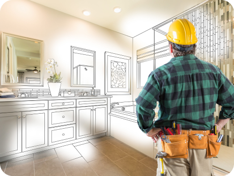 A construction worker is looking at a drawing of a bathroom.