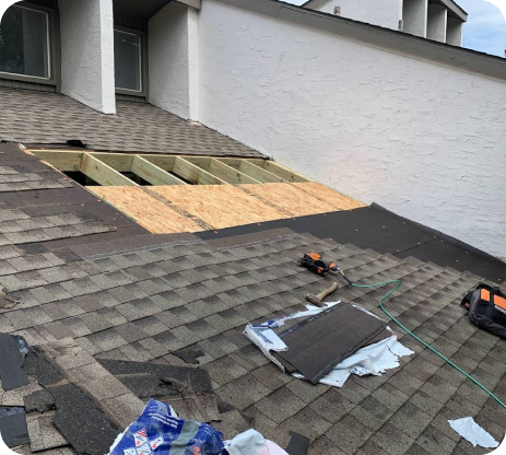 A roof with a hole in it is being repaired.