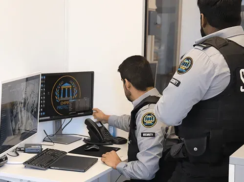 A man is sitting at a desk looking at a computer screen.