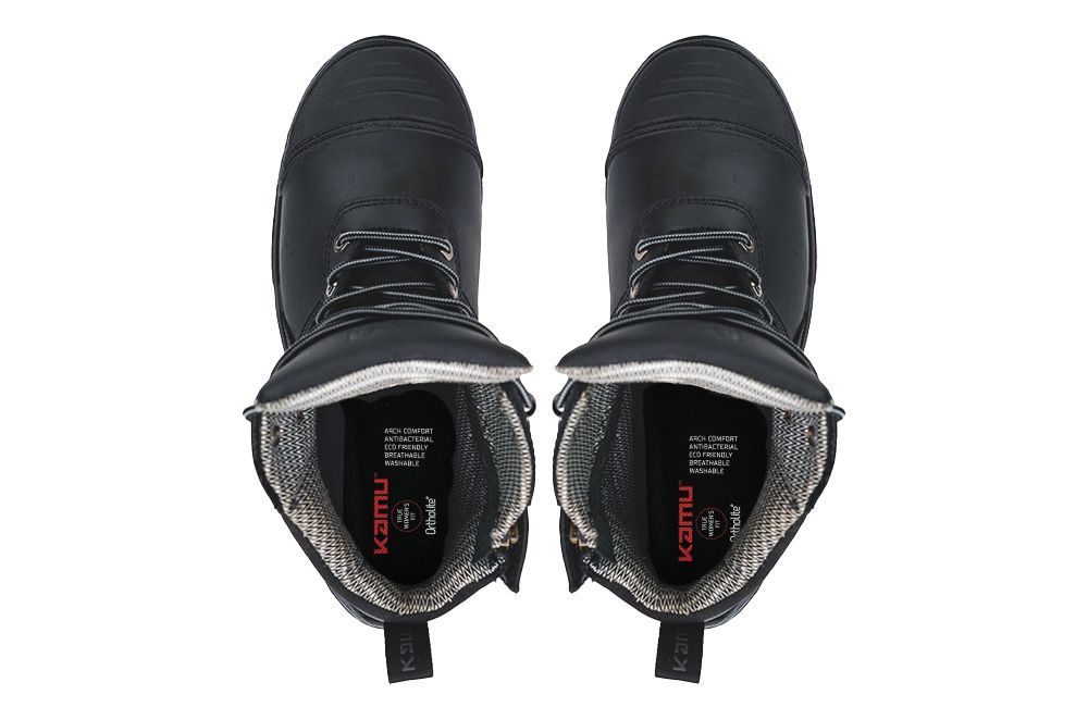 A pair of black boots with the inside of the shoe showing.