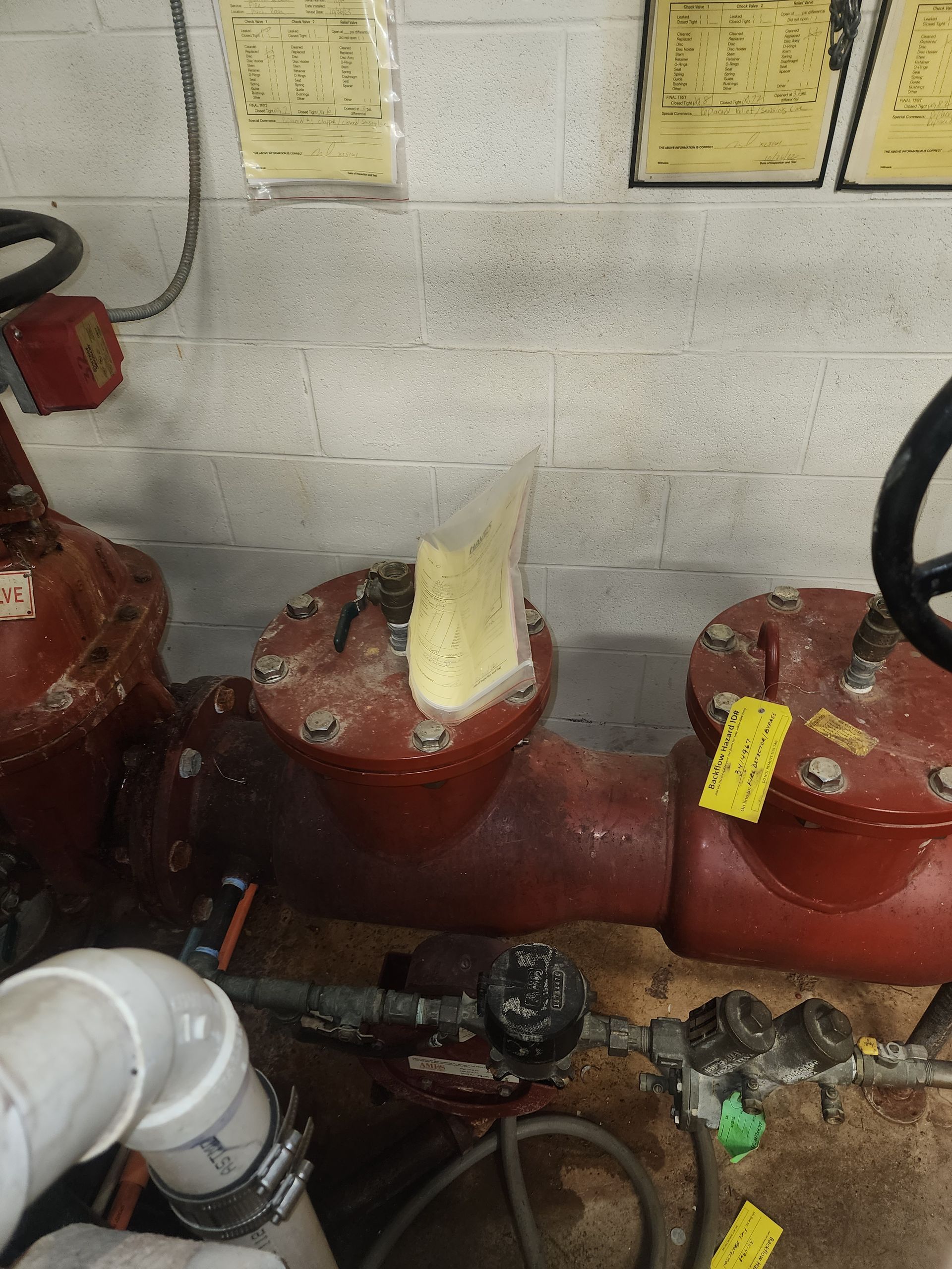 a red pipe with a yellow tag on it