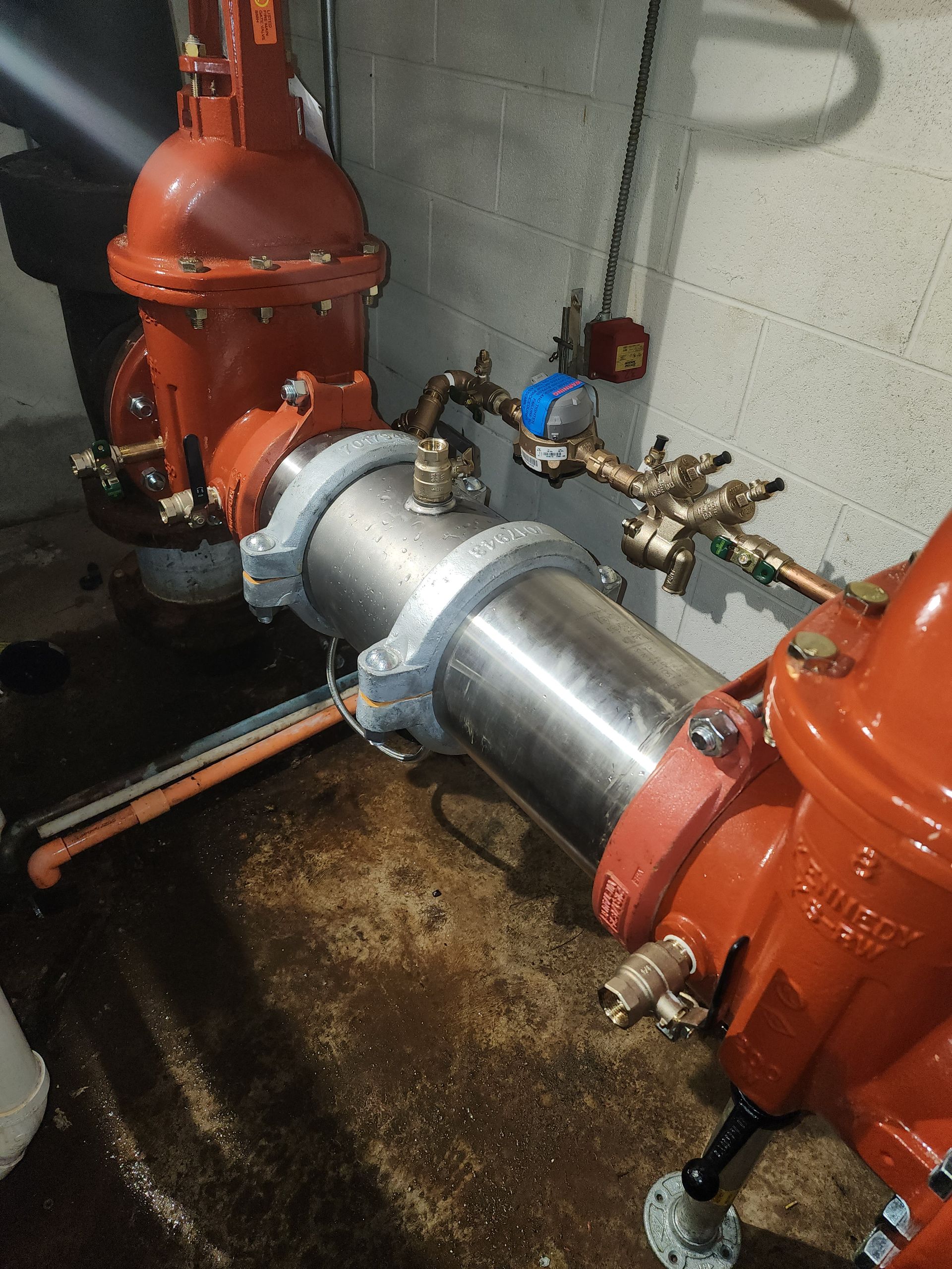 a close up of a pipe with a valve attached to it in a room .