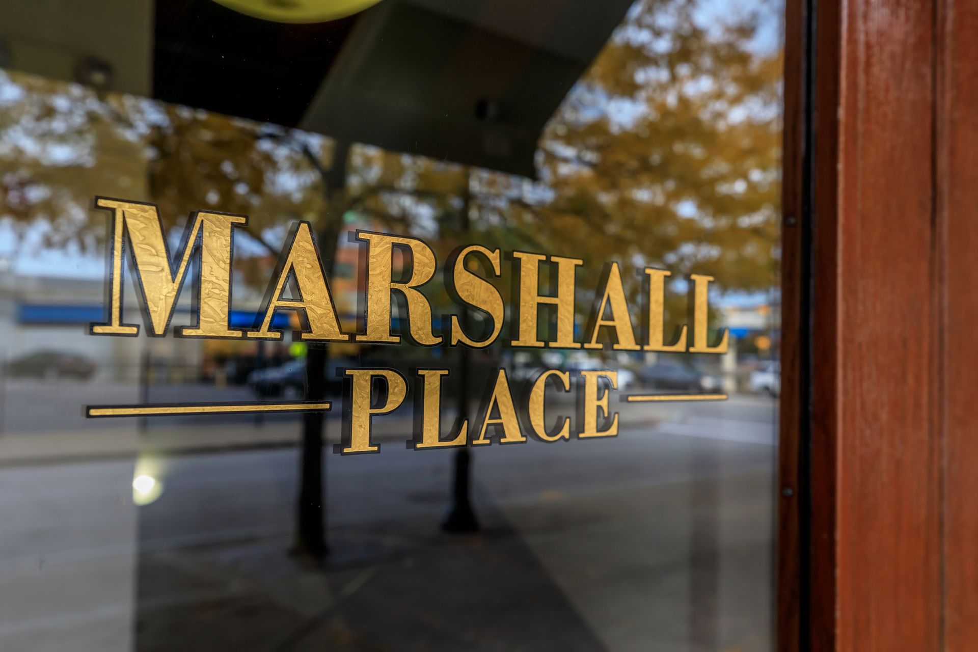 The word marshall place is on a glass door.