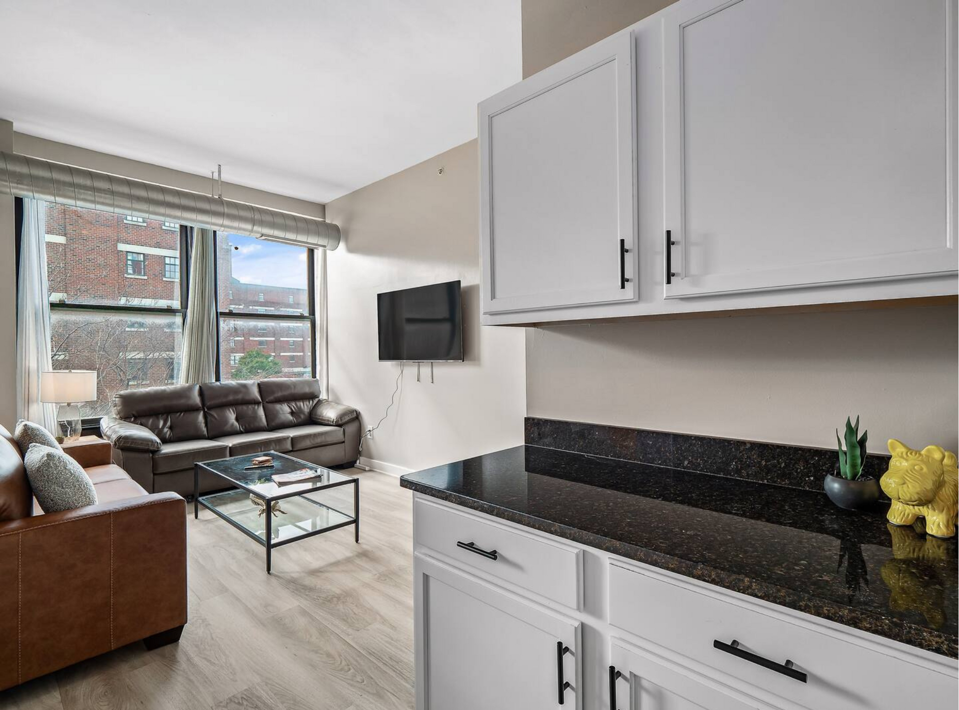A living room with a couch , coffee table , and television.