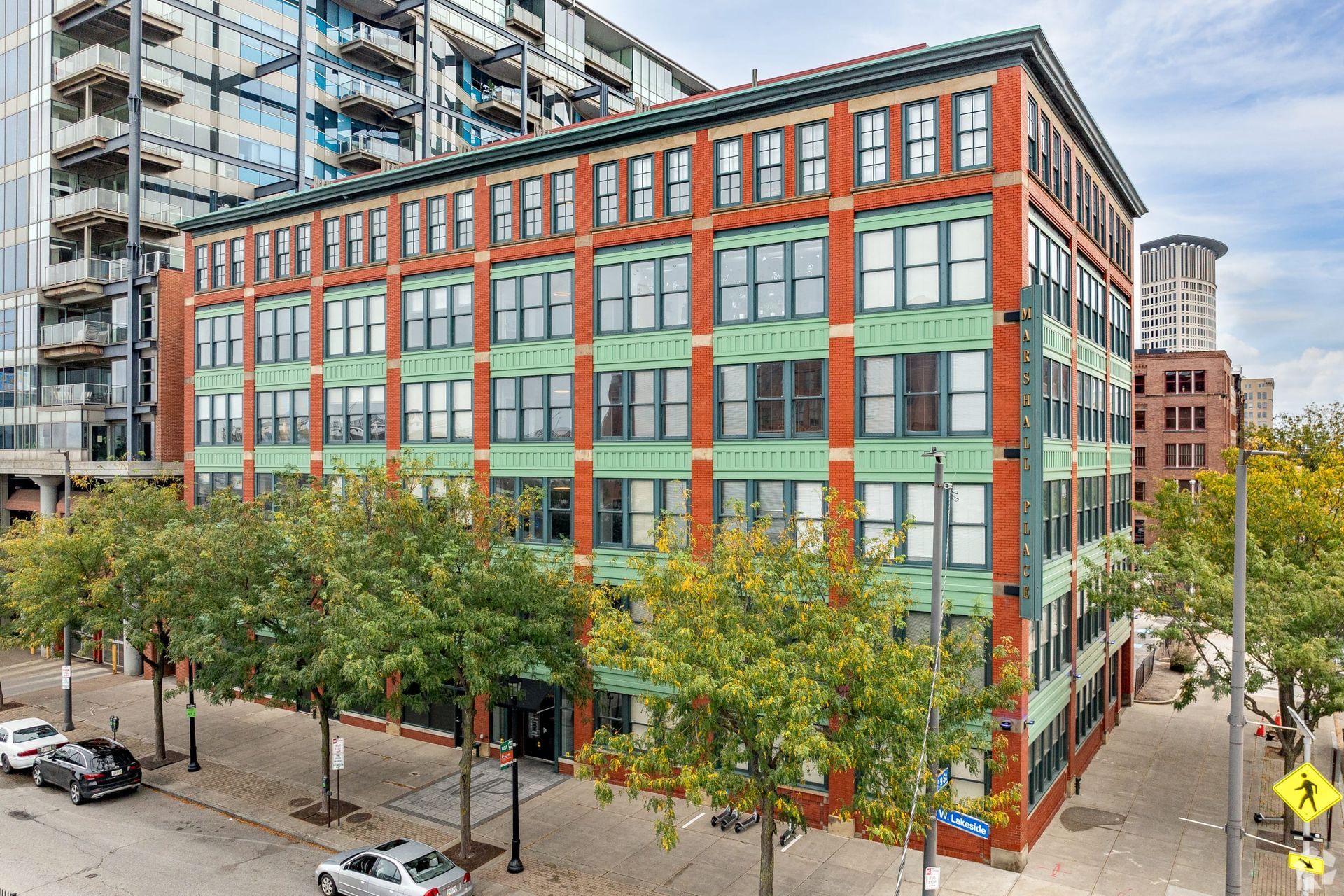 An aerial view of a large building with a lot of windows in a city.