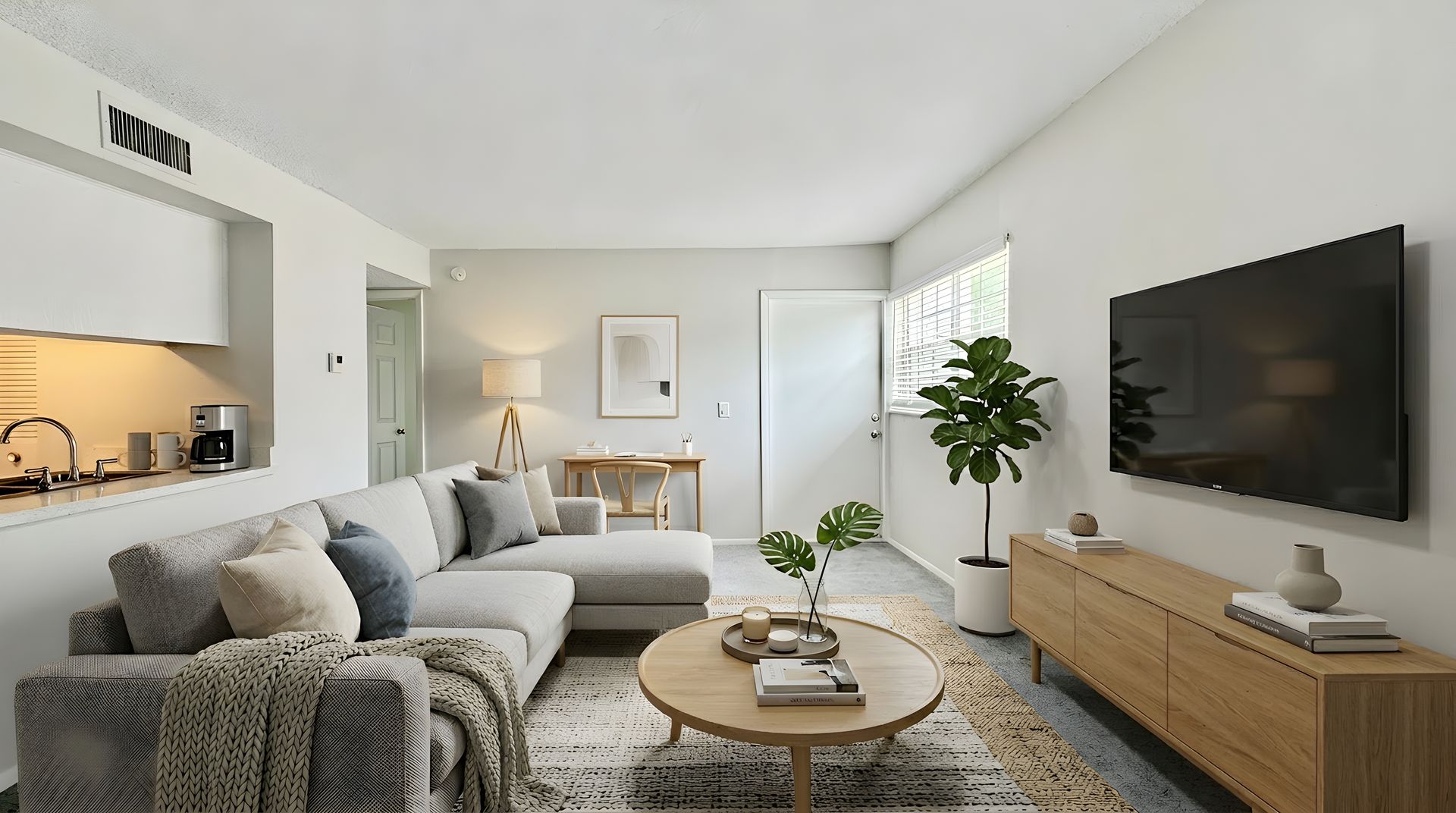 Staged living room with carpet and large couch