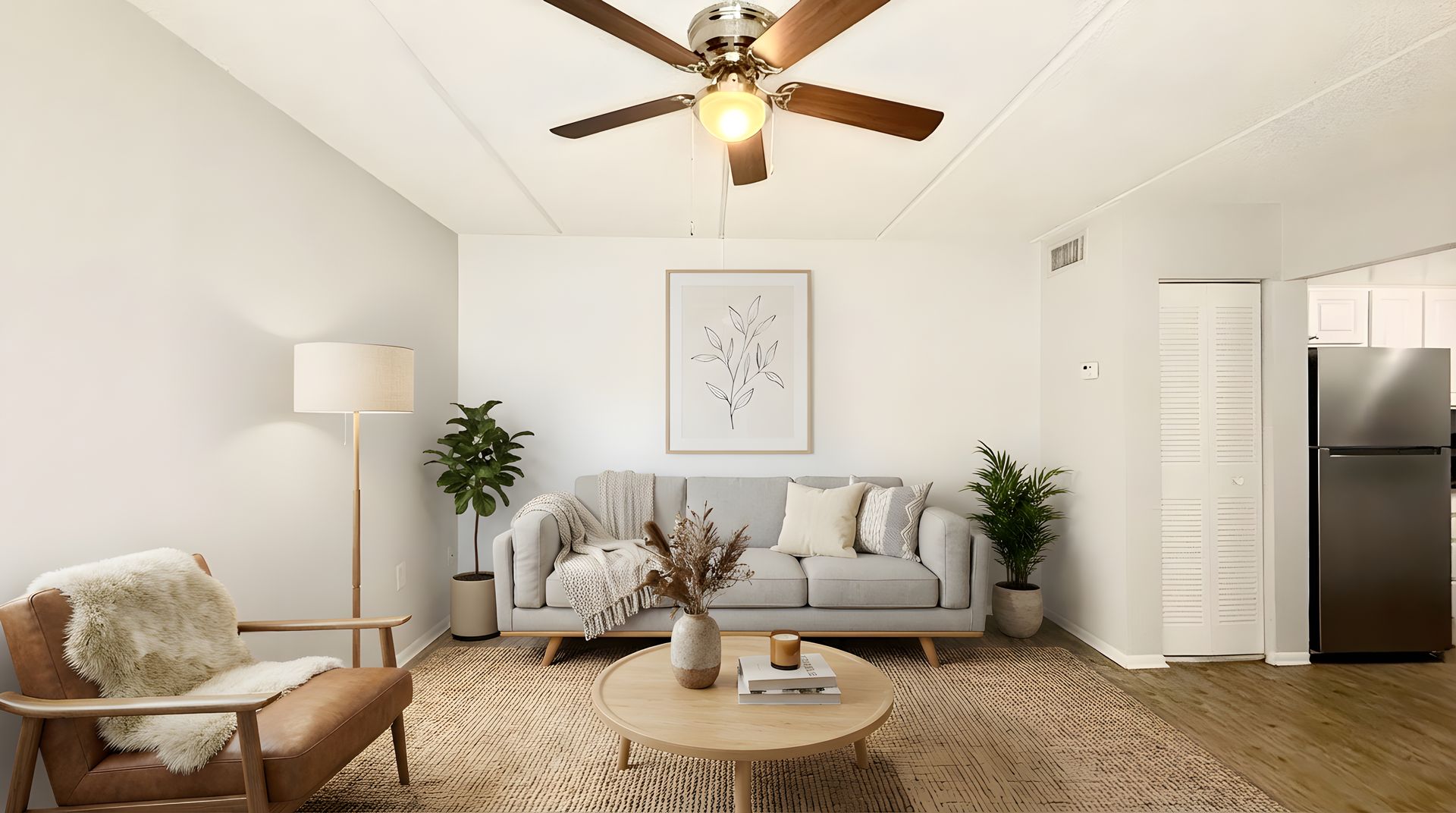 Staged living room with light floors and sofa set