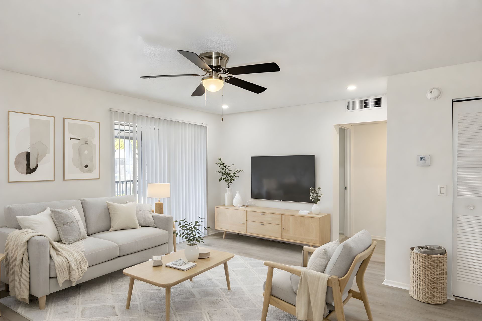 Staged living room with light floors and sofa set