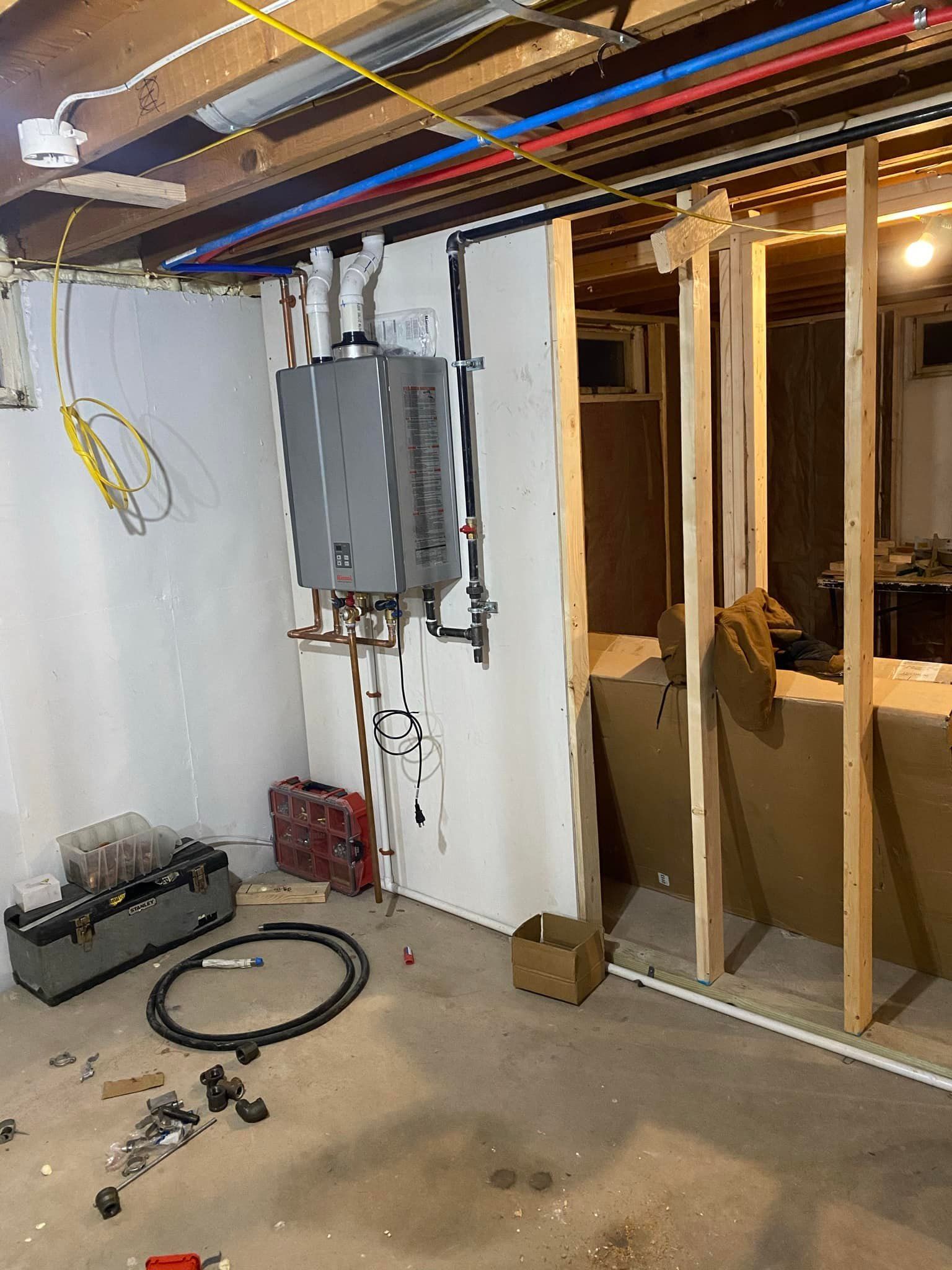 A basement with a lot of wires hanging from the ceiling.