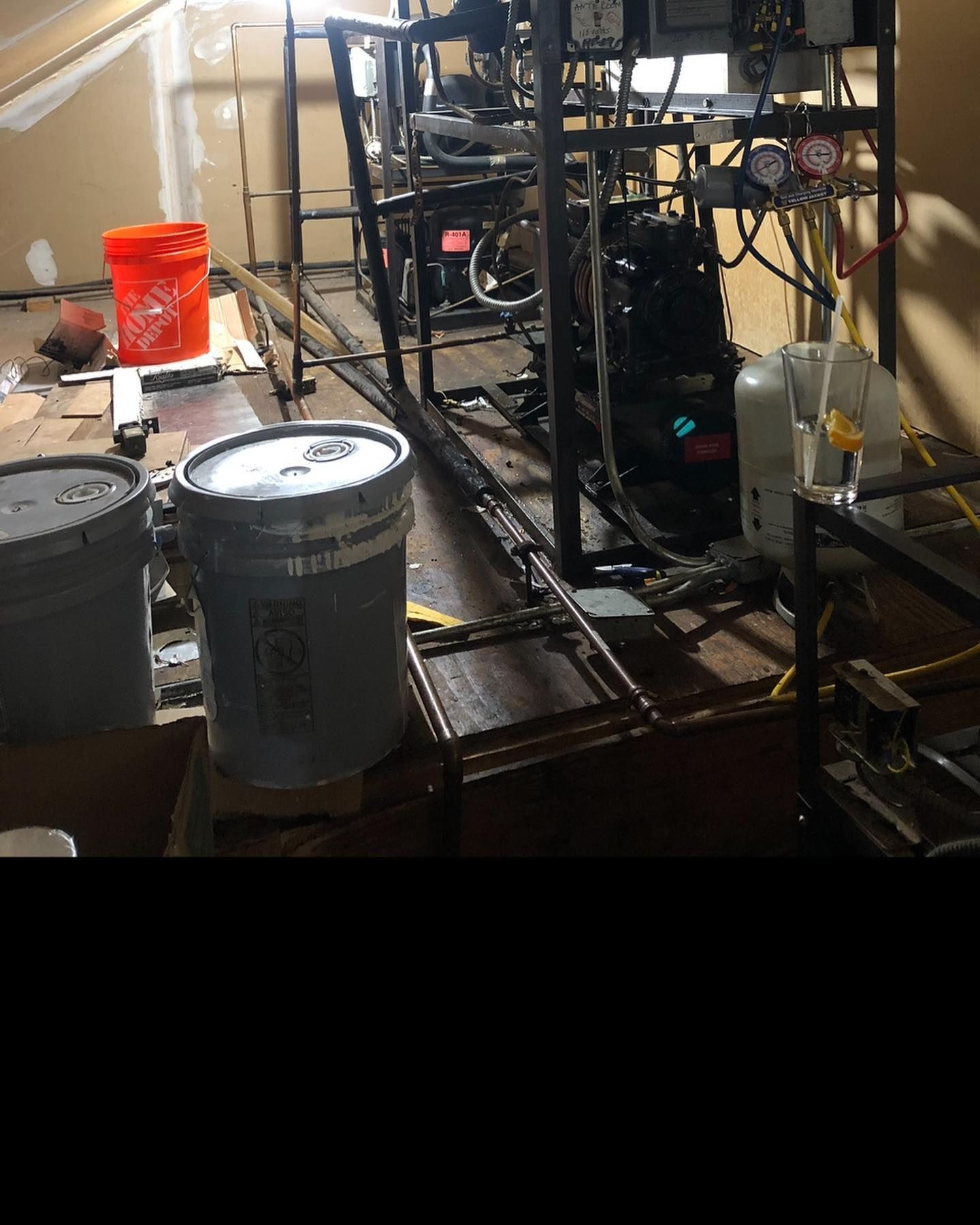 A room with buckets and a machine in it