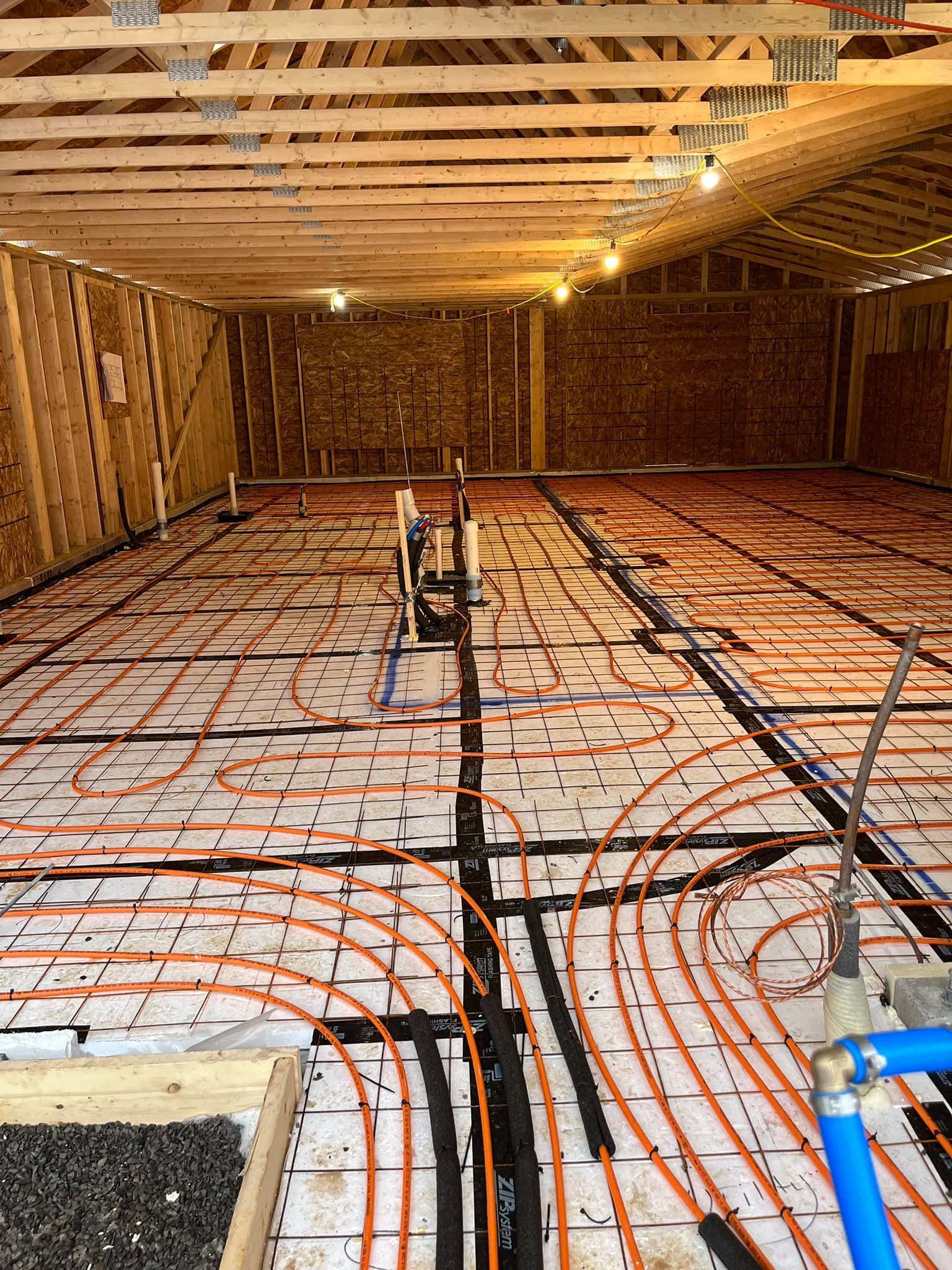 A large room with a lot of pipes on the floor.