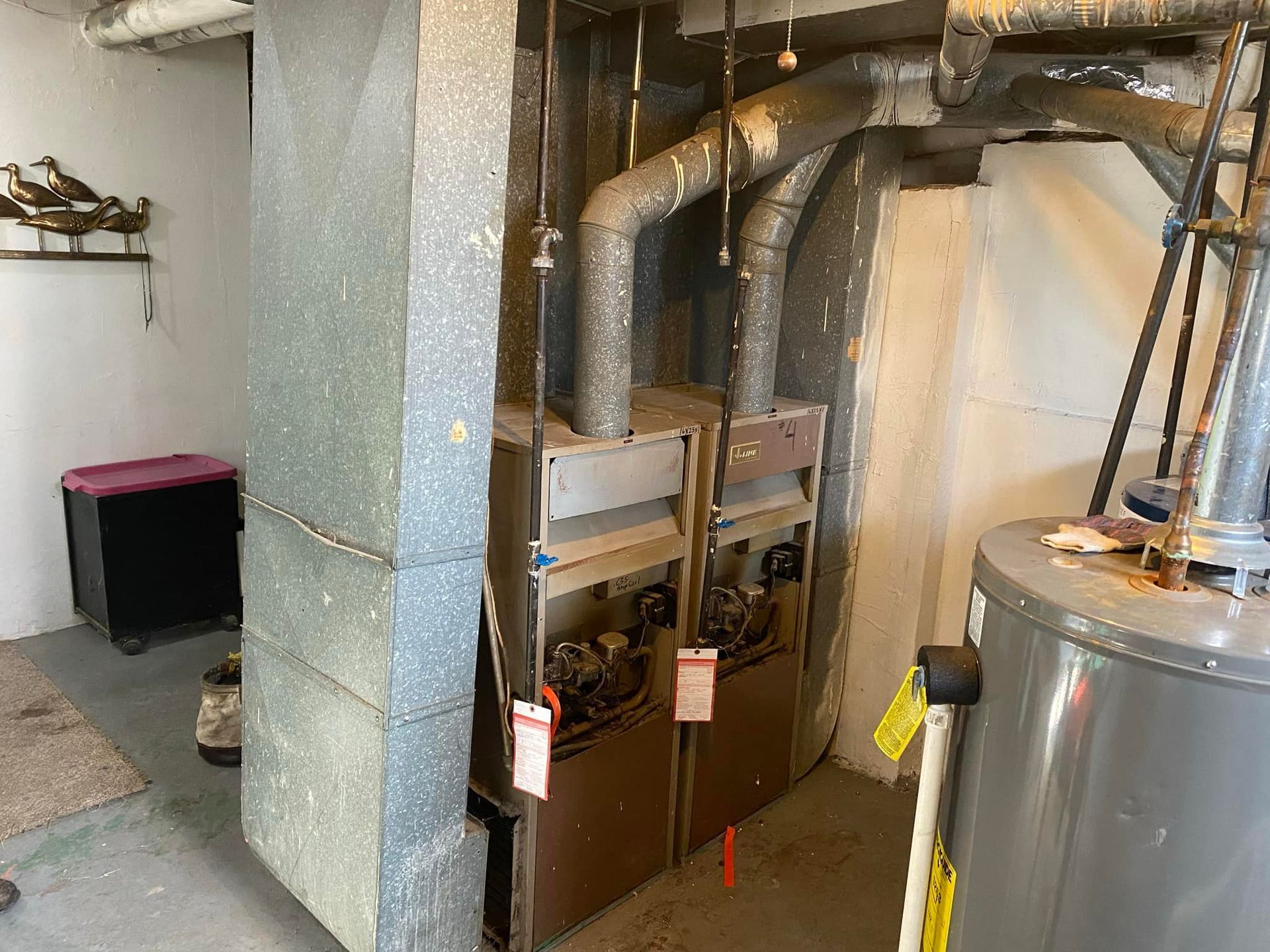 A room with two heaters and a water heater in it.