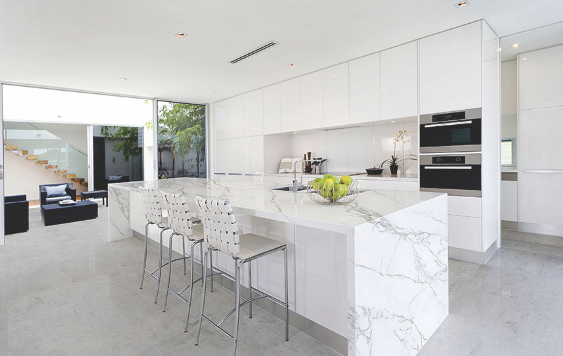 A bathroom sink with a marble counter top and a faucet.