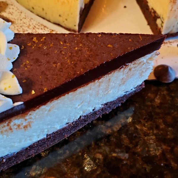 A close up of a slice of cheesecake on a plate