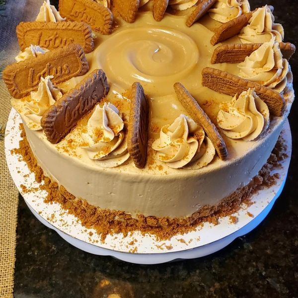 A cake with lotus cookies on top of it