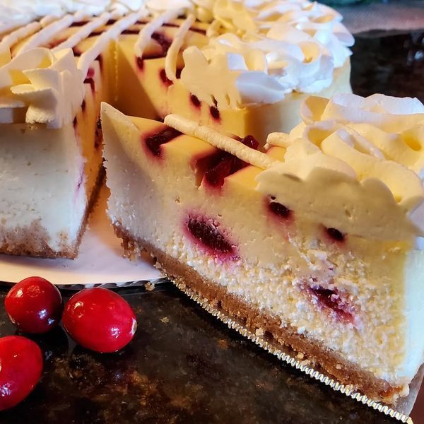 A cheesecake with a slice taken out of it