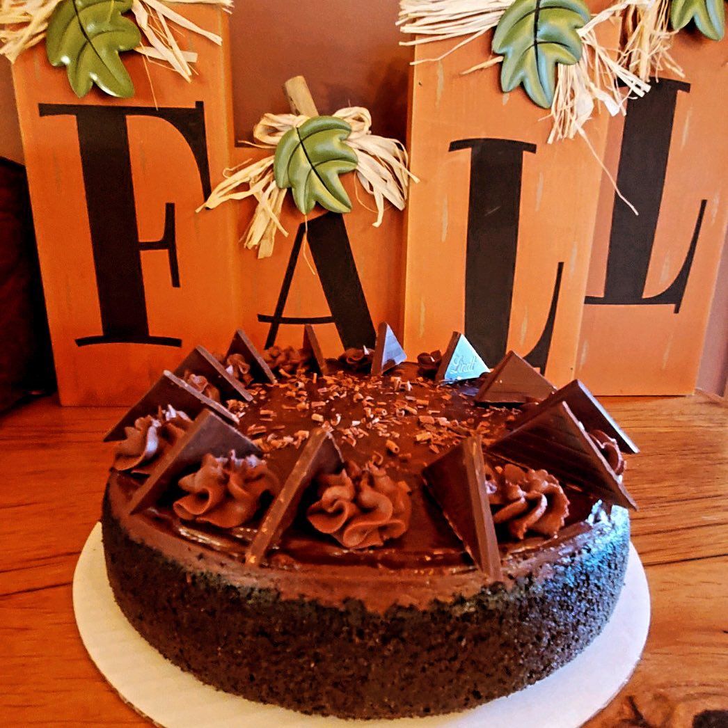 A chocolate cake with a fall sign in the background
