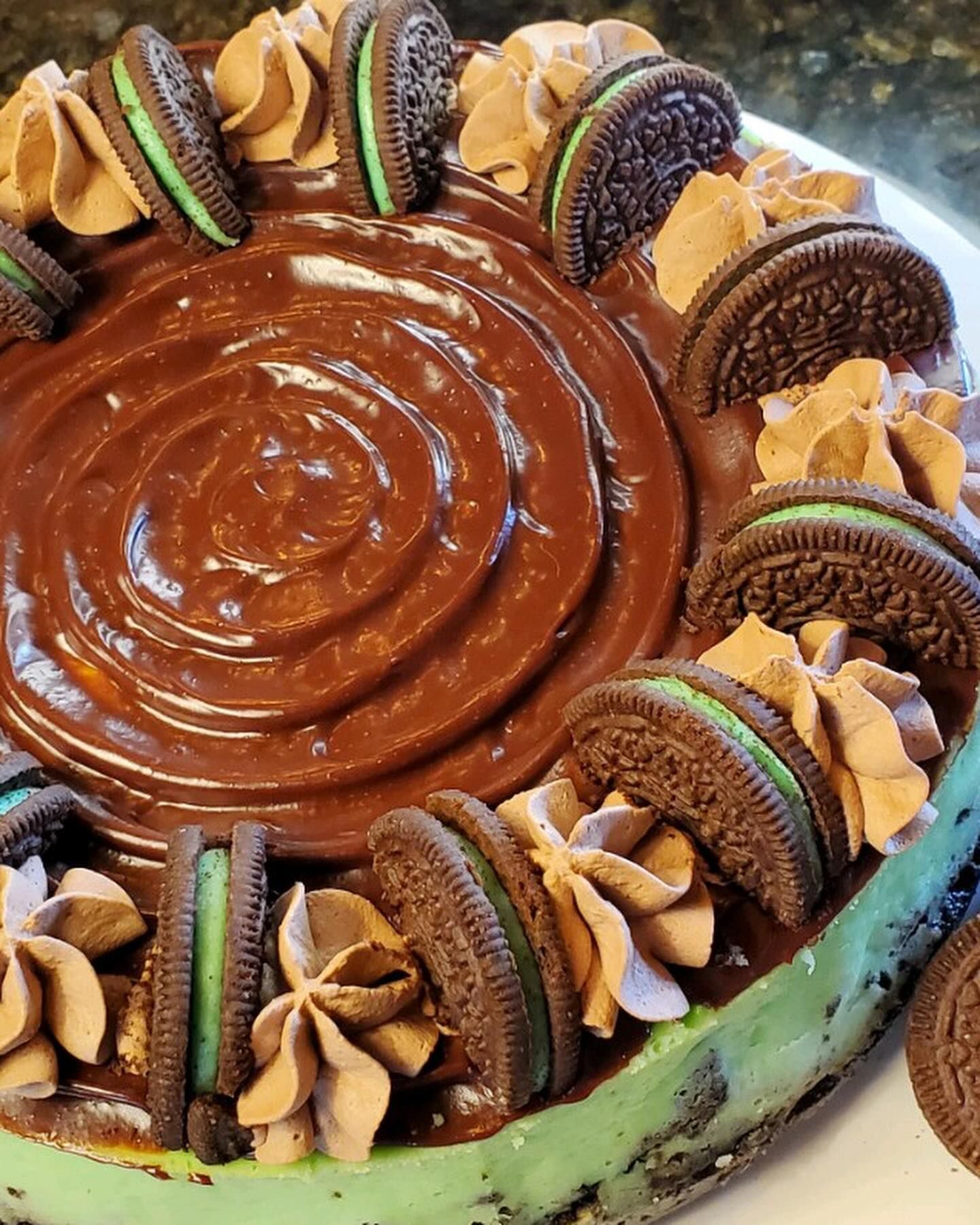 A cake with chocolate frosting and oreos on top