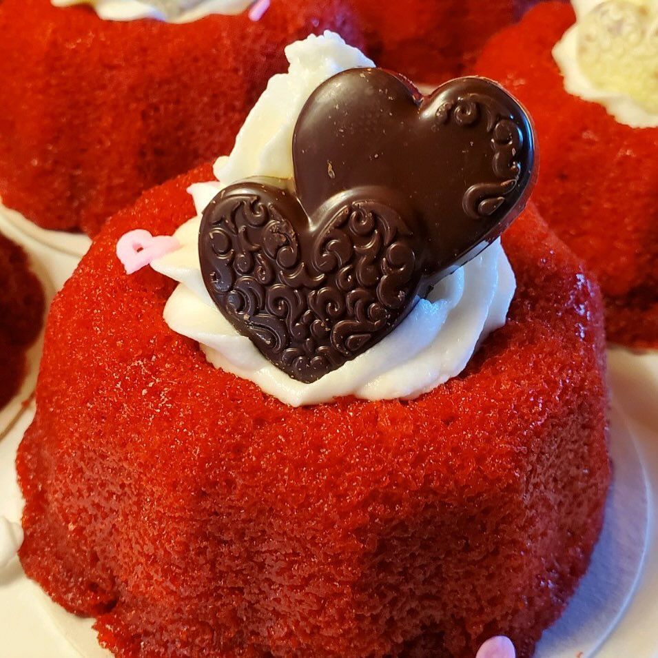 A red velvet cake with a chocolate heart on top