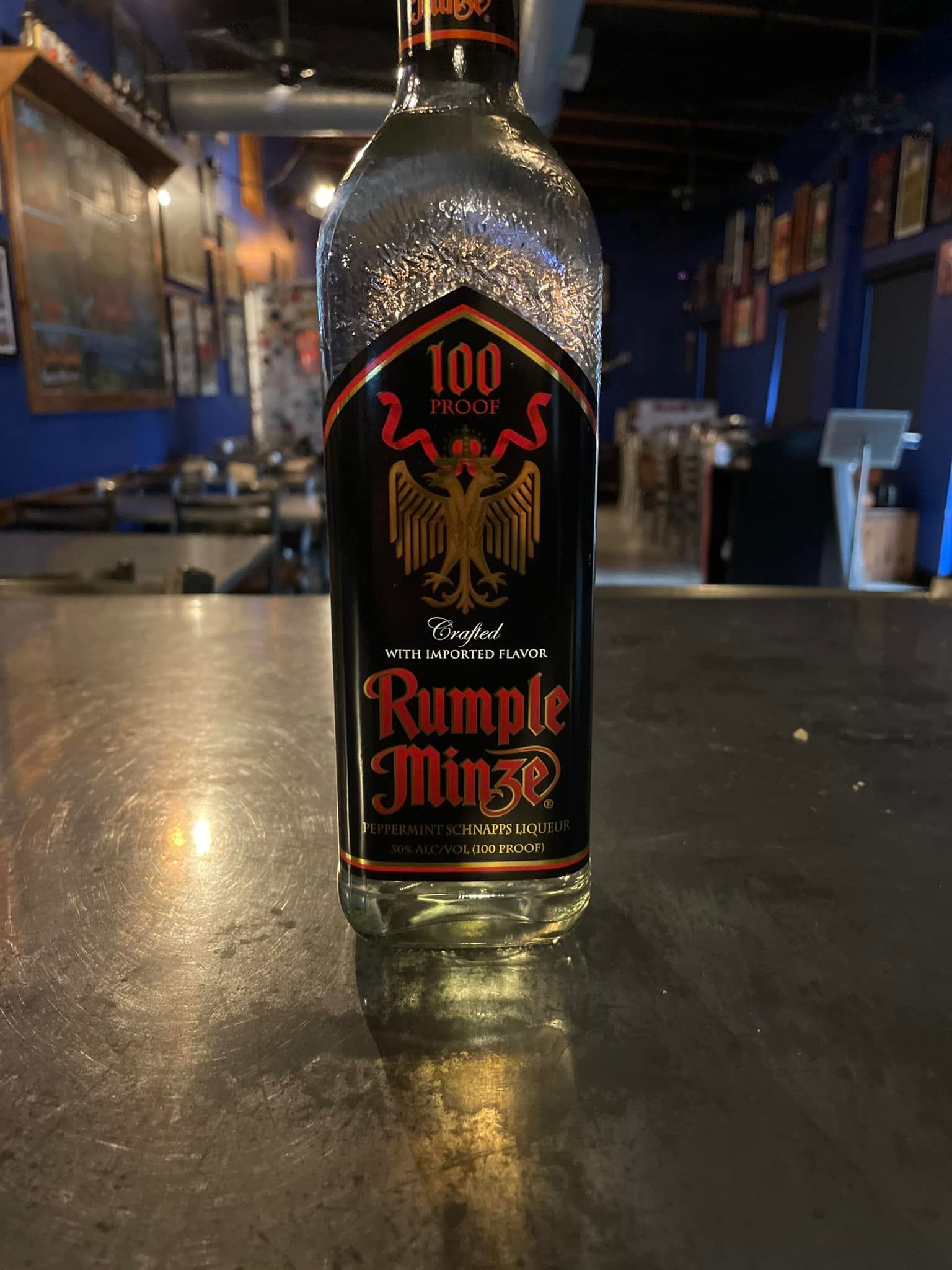 A bottle of rum is sitting on a counter in a restaurant.