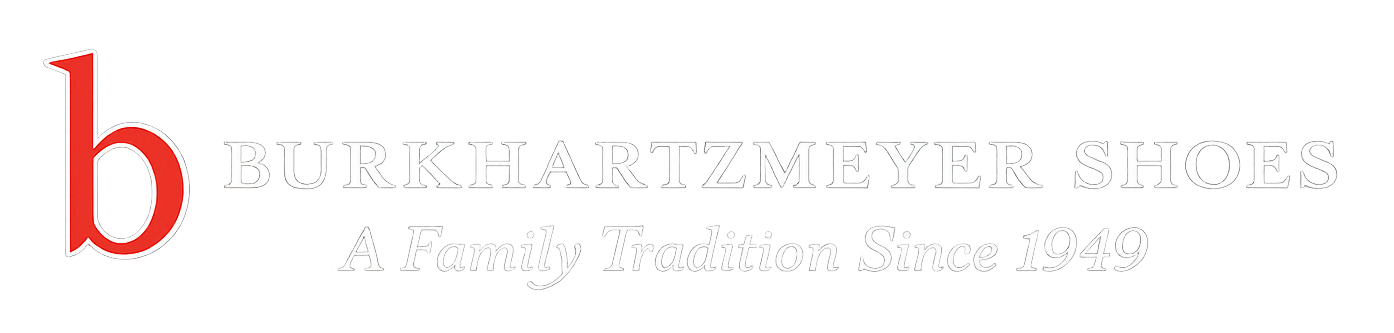 White logo with a red lowercase “b” and faint gray text reading “Woolly Institute” with a small tagline below.