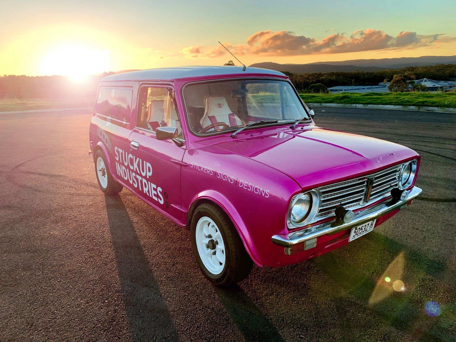 Pink Vintage Mini Van Parked on Pavement with Sunset in Background — Stuckup Industries in Morisset, NSW