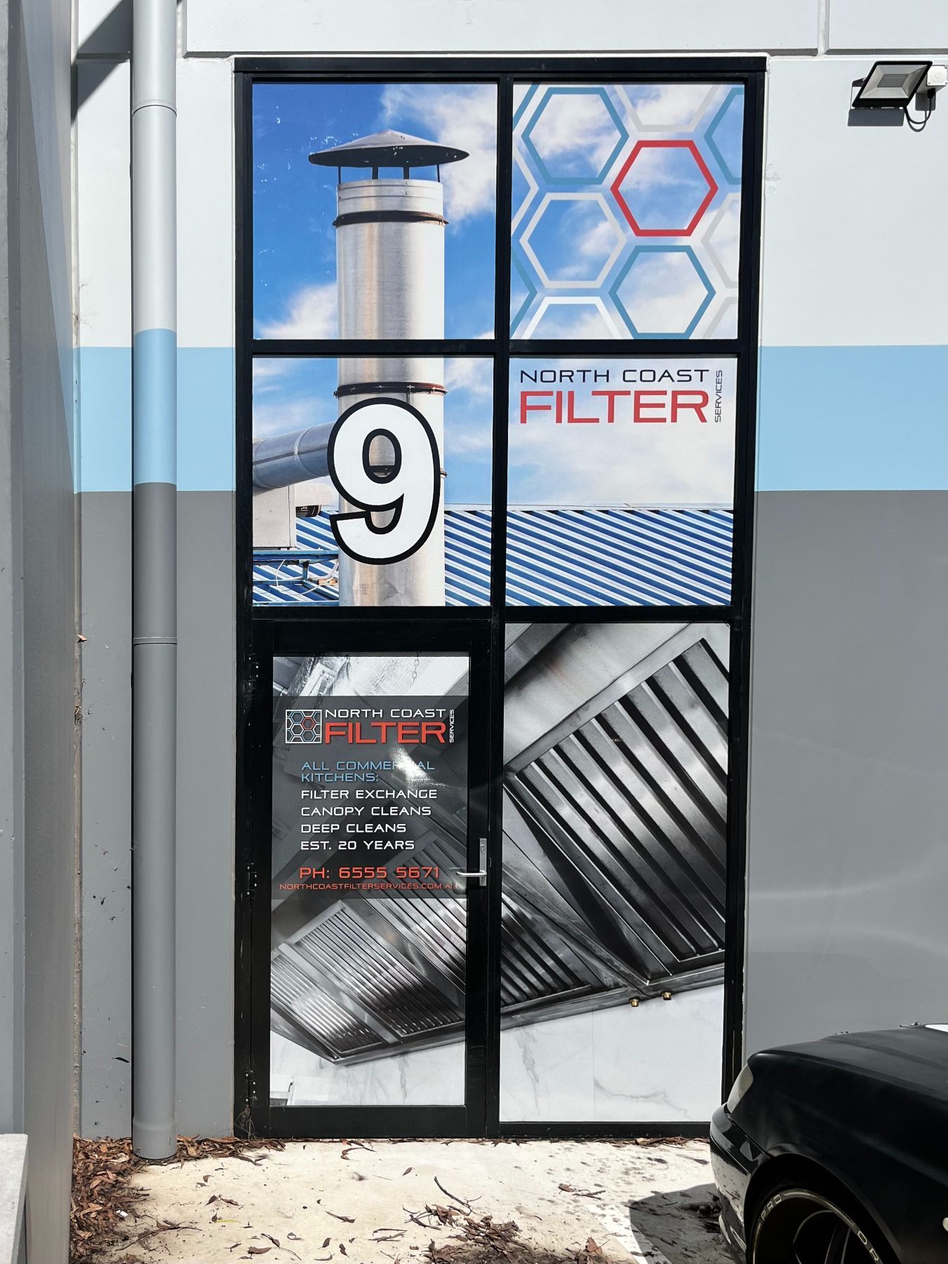 Building entrance with window decals: chimney, 