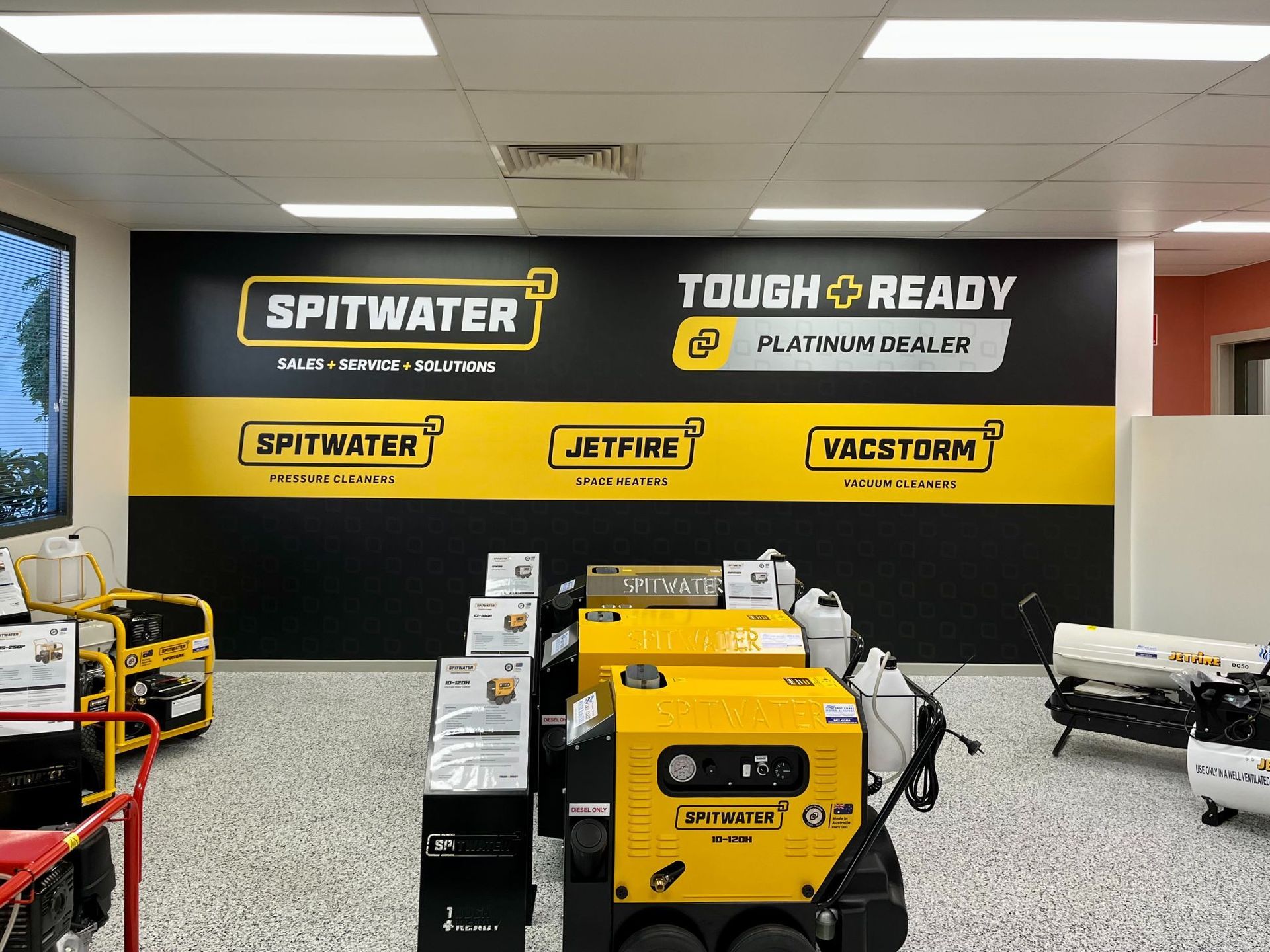 Interior of a store, displaying heavy machinery and branding for 