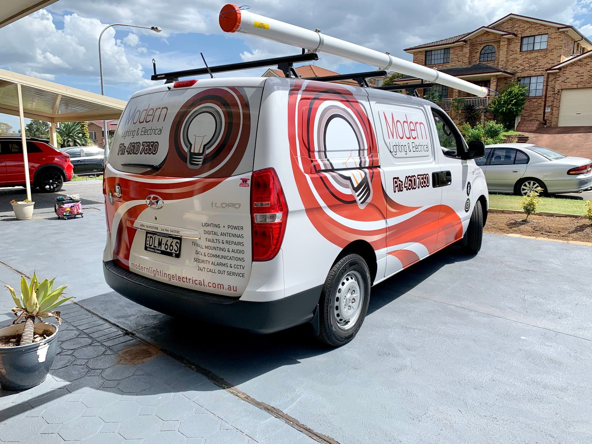 A White Van with Red and Brown Graphics Parked in A Driveway — Stuckup Industries in Morisset, NSW