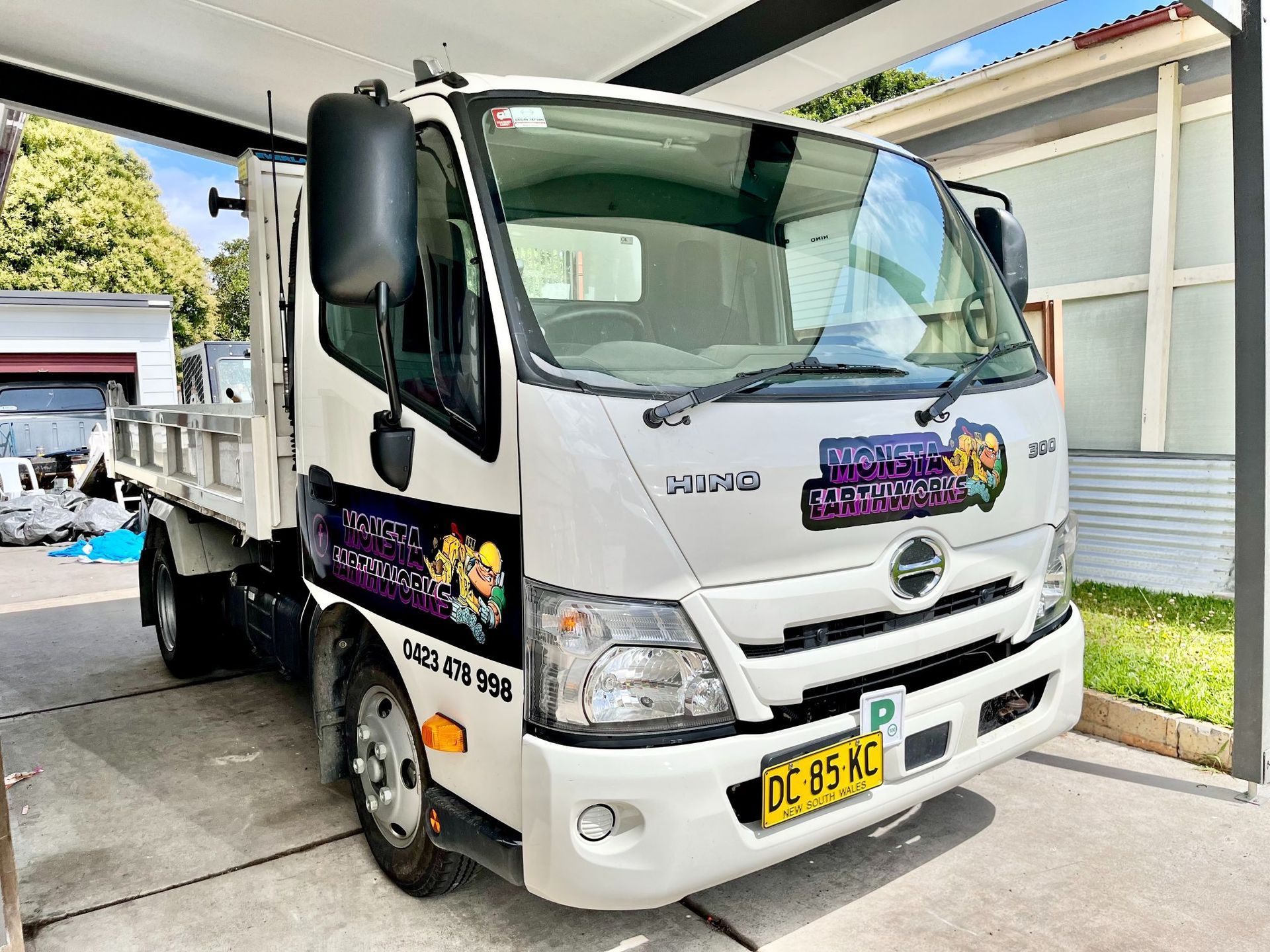 A Truck With Purple Logos On It
