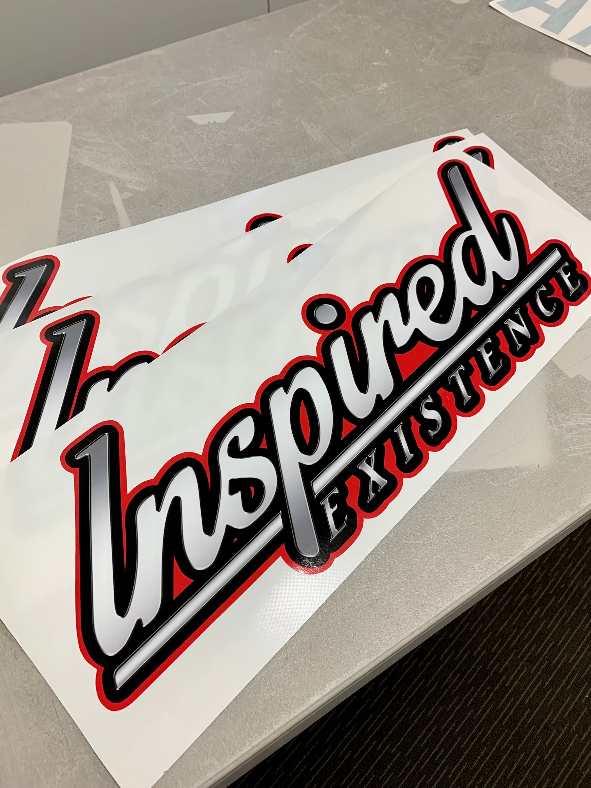 A Printed Sticker With the Word Inspired On It