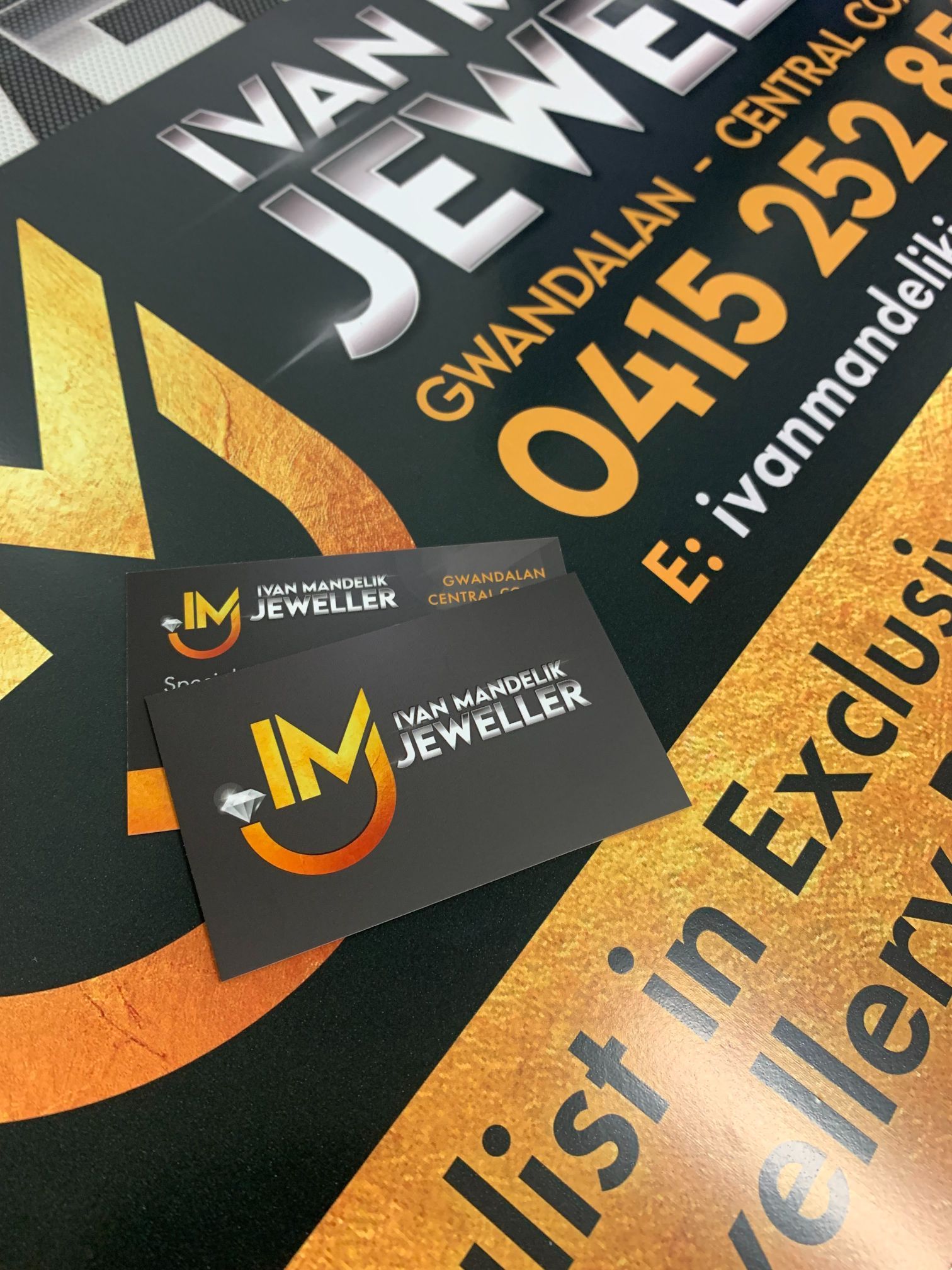 Business cards on a promotional flyer for Ivan Mandelik Jeweller in black and orange.