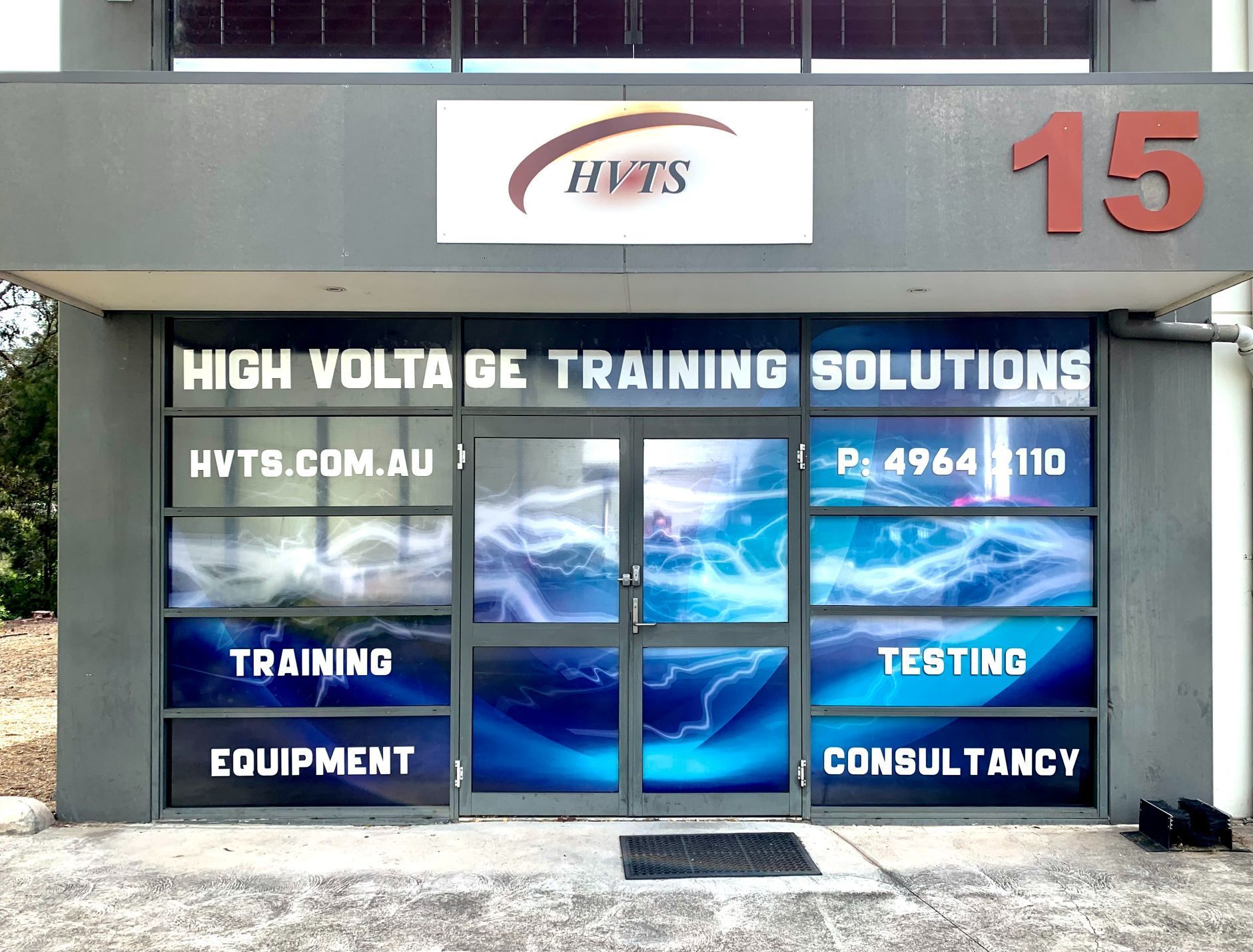 Exterior of A Building with Window Displays of Lightning and Services Offered — Stuckup Industries in Central Coast, NSW