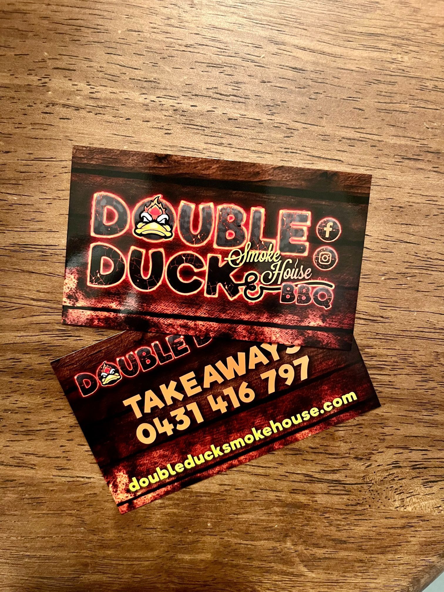 Two Double Duck BBQ Business Cards on A Wooden Surface — Stuckup Industries in Central Coast, NSW