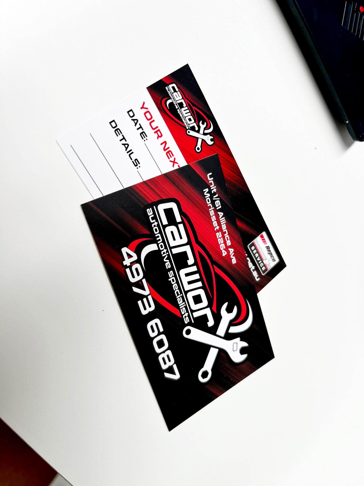 Business cards for Carworx Auto Repair, featuring a logo, phone number, and reminder section.