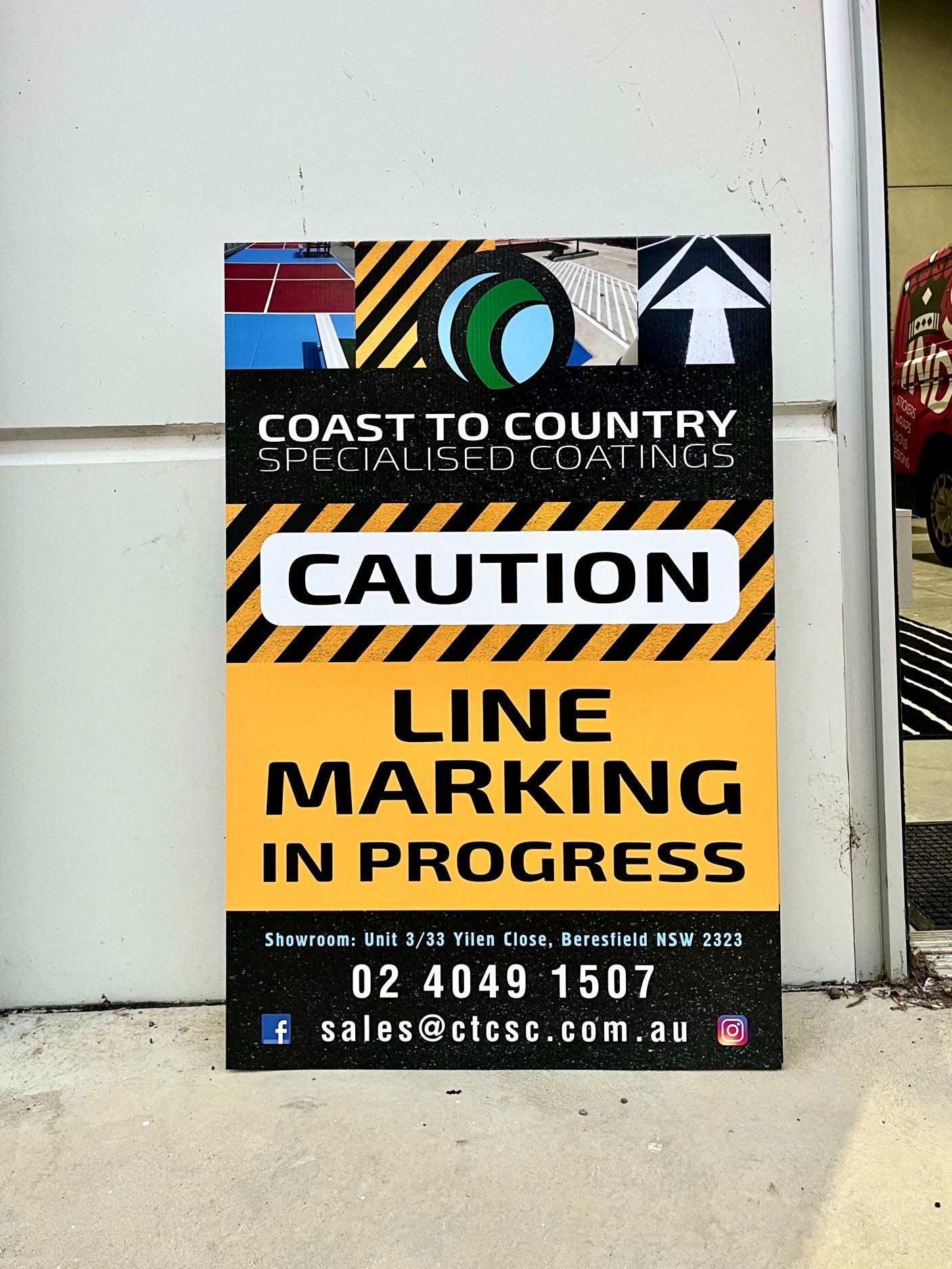 Sign with Caution Line Marking in Progress and Logo of Coast to Country — Stuckup Industries in Morisset, NSW