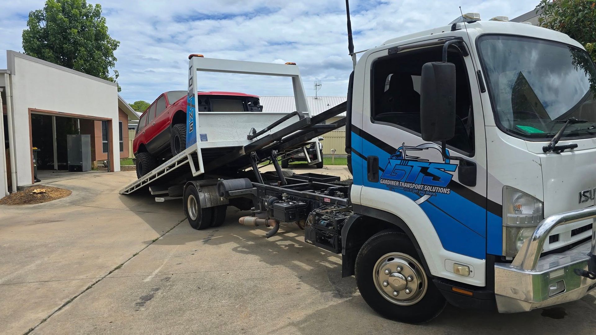 Tow Truck With a Red Suv on Its Flatbed — GTS - Gardiner Transport Solutions in Berserker, QLD
